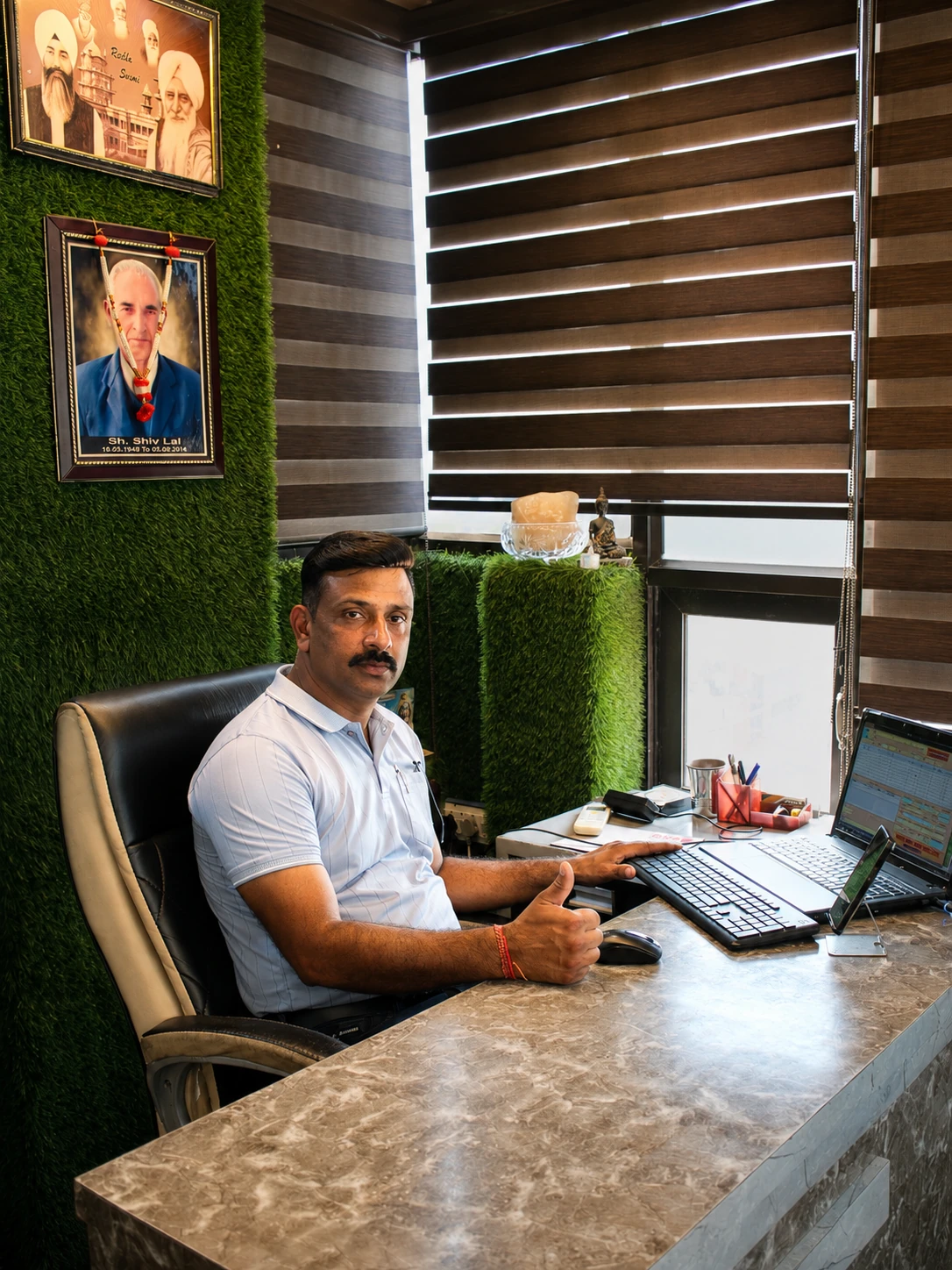 Er. Tarlok Chand seated at his office desk