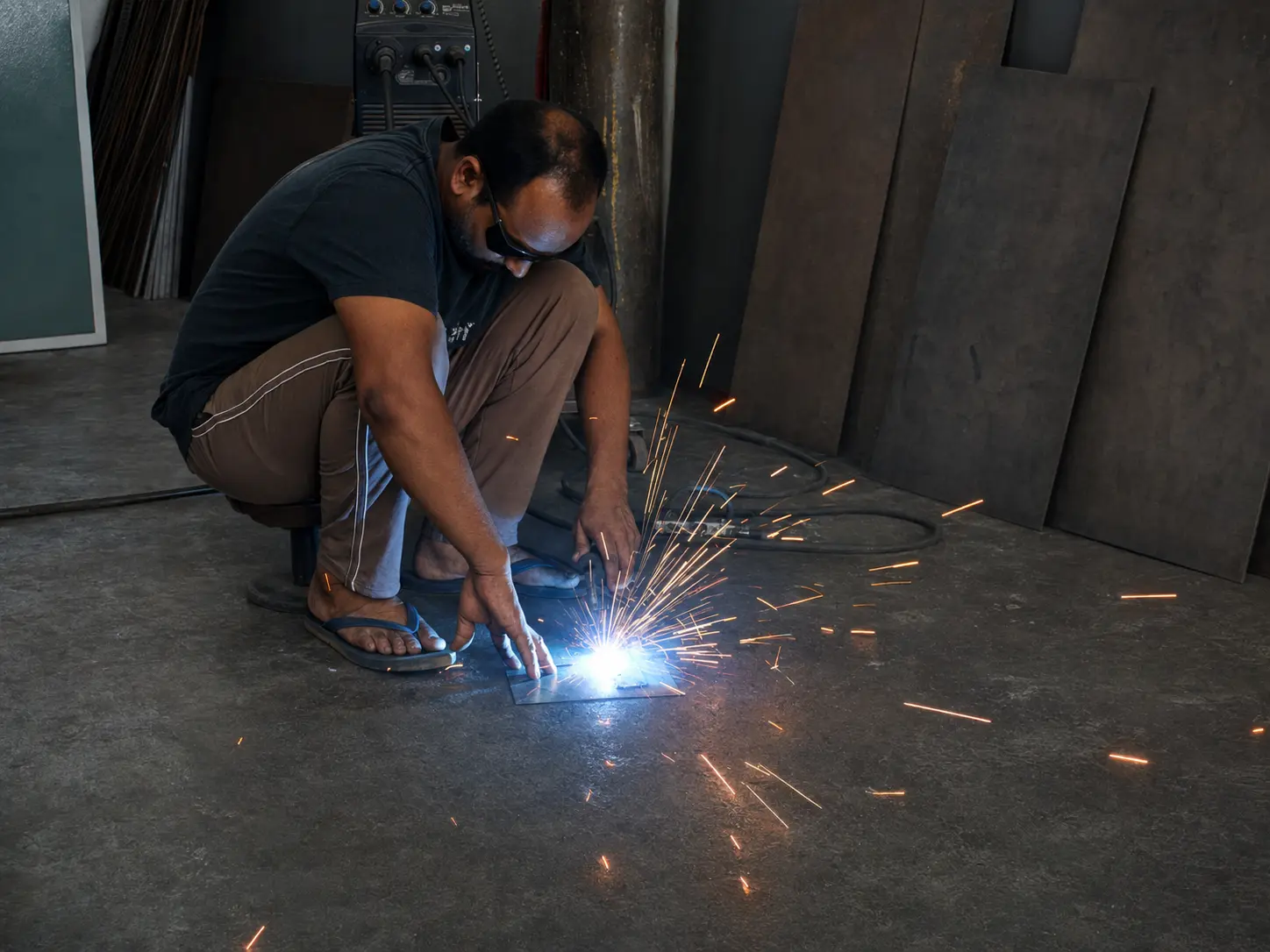 Craftsperson MIG welding steel components