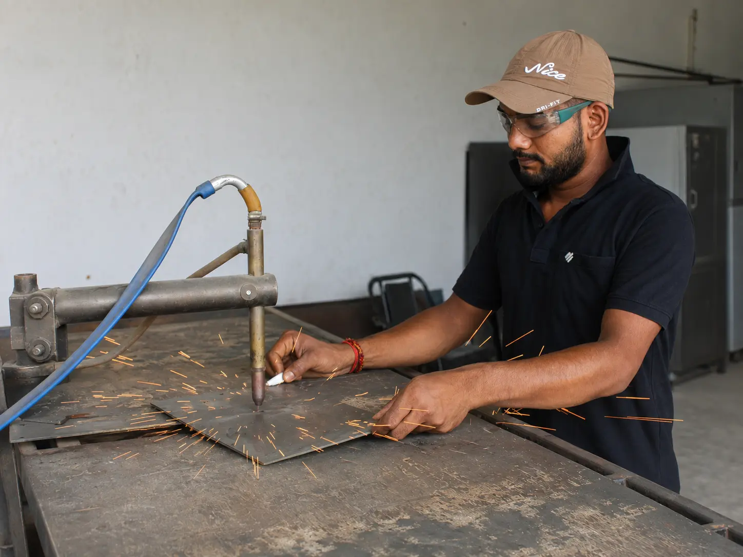 Craftsperson spot welding a steel panel
